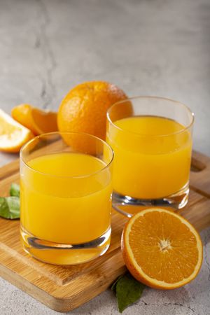 Glass with orange juice on the table.