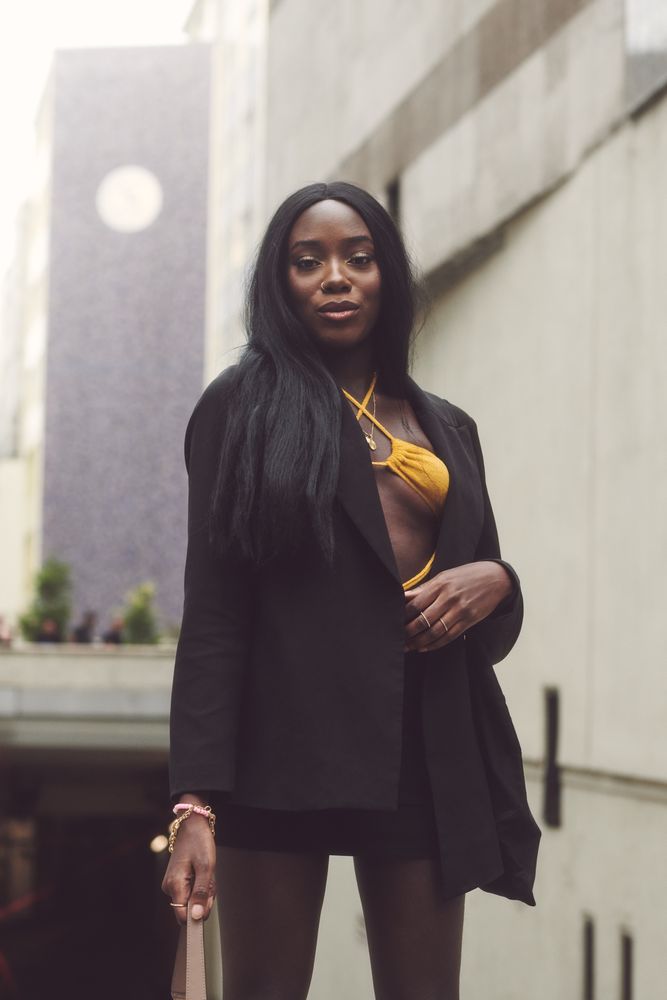 London, England, United Kingdom - September 18 2021: Woman in blazer with orange bikini