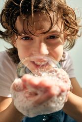 Cute boy with soap bubble