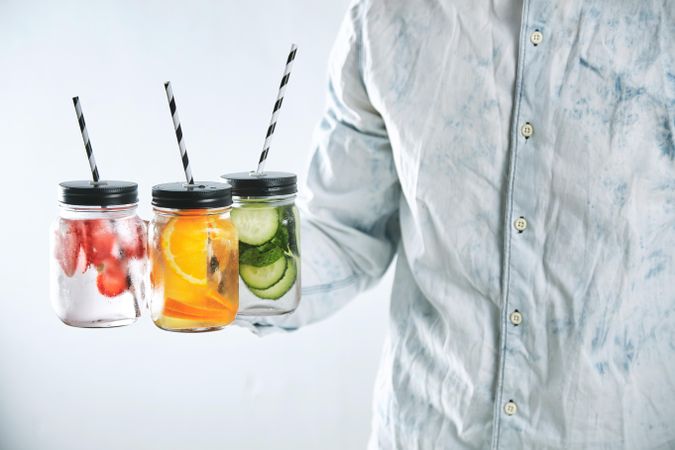 Healthy drinks made from strawberry, orange, cucumber, mint, ice and sparkling water in rustic jar