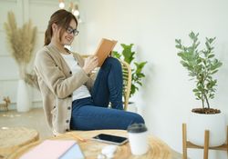 Beautiful woman sitting in the living room reading a book.