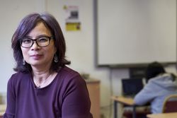 Mature woman teacher sitting in classroom