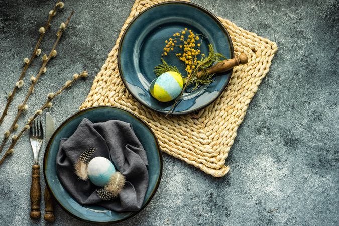 Easter holiday table setting with Easter egg & feather