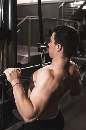 Young fitness man training in gym