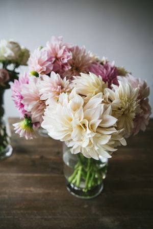 Bunches of flowers in vases on table