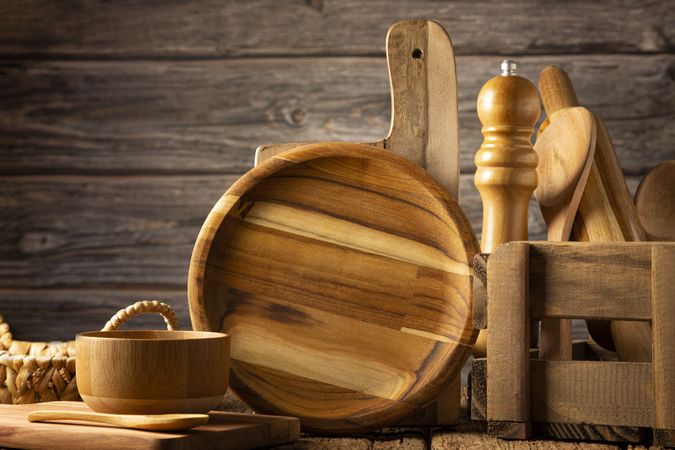 Wooden kitchen utensils on rustic background.