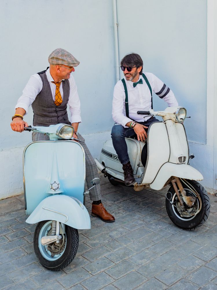 Trendy  men sitting on vintage scooters