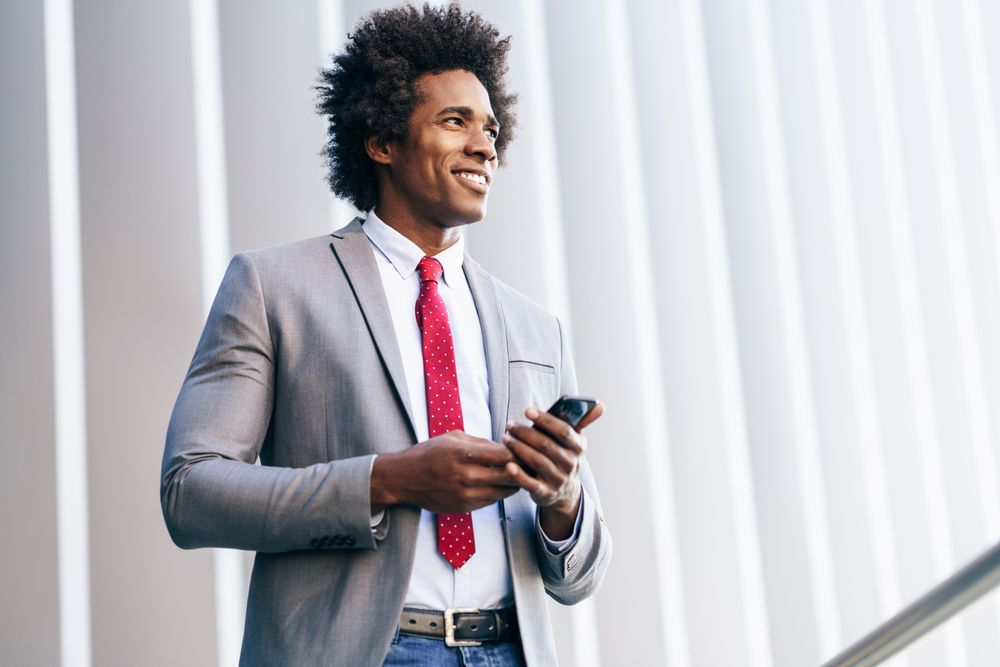 Calm man texting on his phone