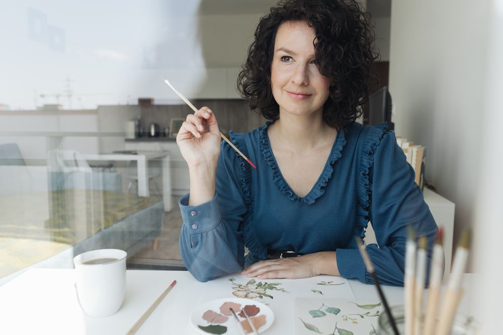 Woman painter working at home