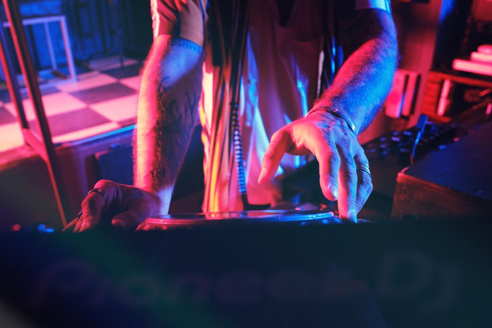 Unrecognizable DJ playing music in club