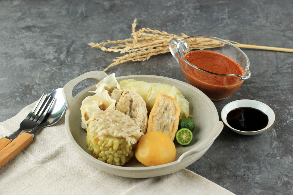 Plate of steamed dumplings, Baso Tahu Indonesian street food served with peanut and soy sauce