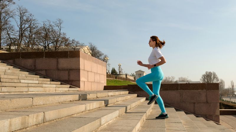 Young woman running on city streets