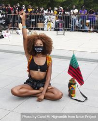 Woman sitting with raised fist at Black Lives Matter event, Washington, DC 43lKOb