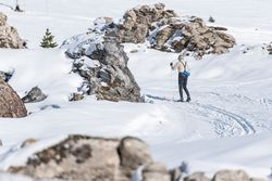 Anonymous skiing in mountainous terrain in winter