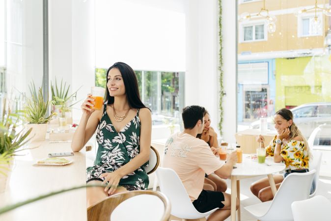 Woman with healthy drink sitting in cafe