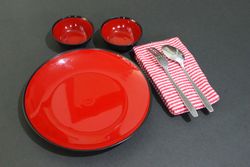 Minimalist table setting with red plates