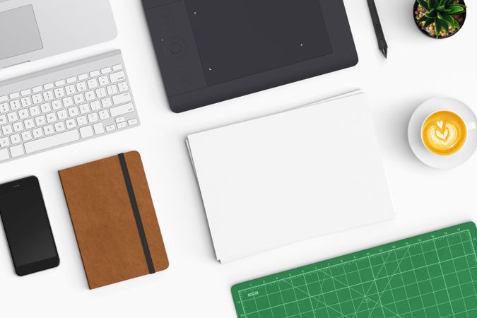 Modern workspace with coffee cup, smartphone, paper, notebook and tablet copy space