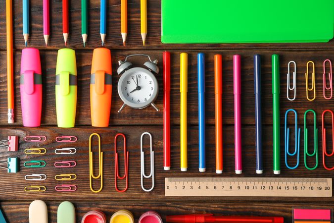 Flat lay composition with school supplies on wooden background
