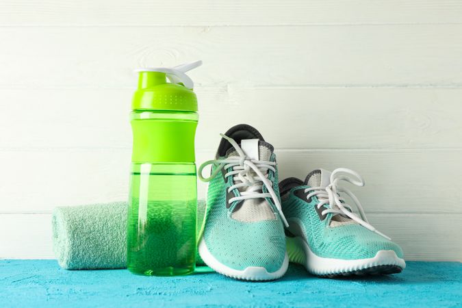 Sport lifestyle accessories on color table against blank wooden background