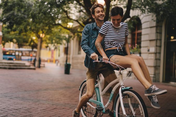 Man and woman riding on a bicycle in the city