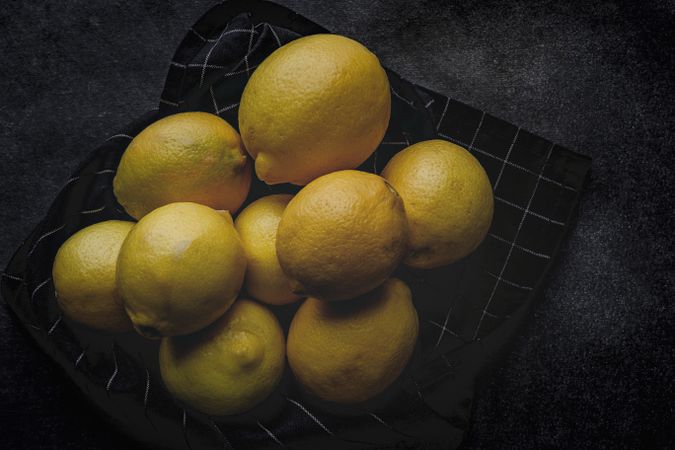 Fresh lemons on dark background.
