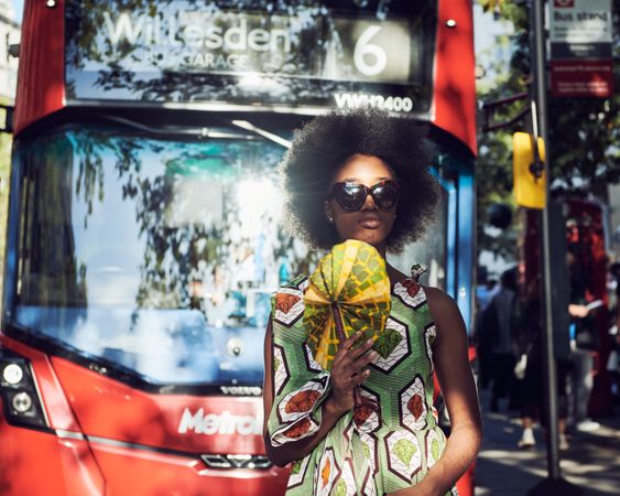 London, England, United Kingdom - September 15th, 2019: Young woman in front of double decker bus