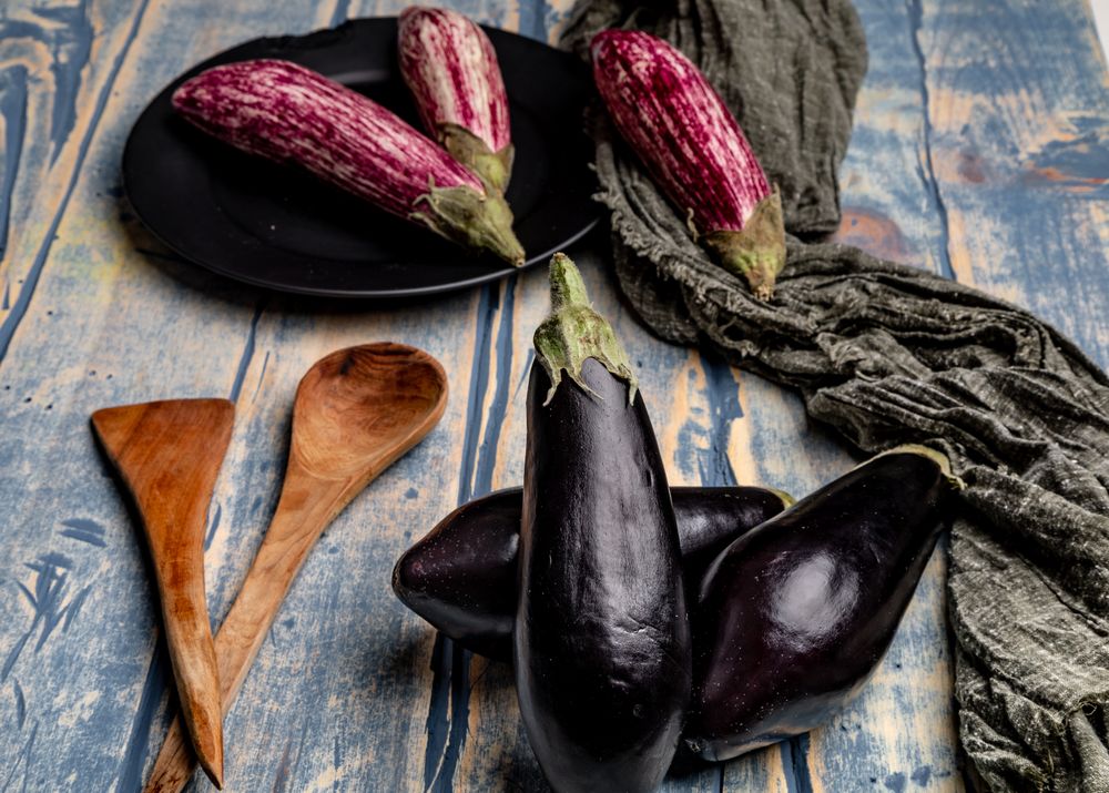 Ripe eggplants on shabby tabletop