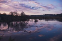 Cloudy evening sky over calm lake