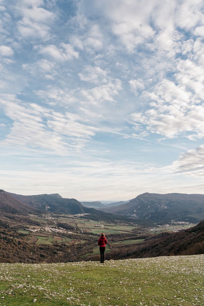 Anonymous woman admiring view of valley and mountains