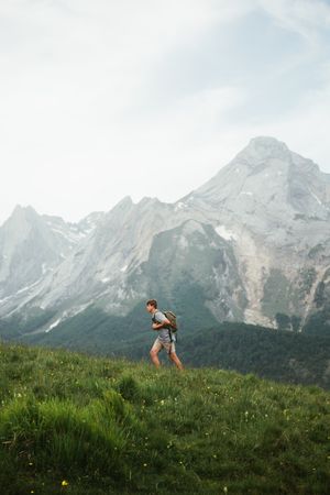 Unrecognizable man with backpack hiking in Pyrenees mountains