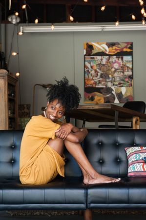 Woman sitting holding knees