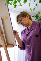 Adult woman painting canvas at home