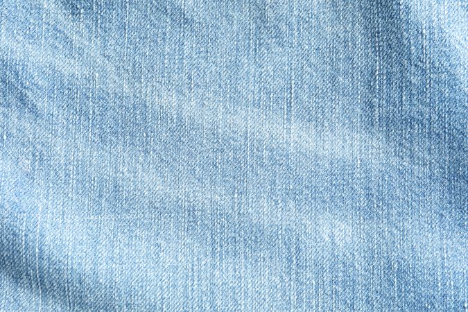 Texture of blue jeans as background, space for text
