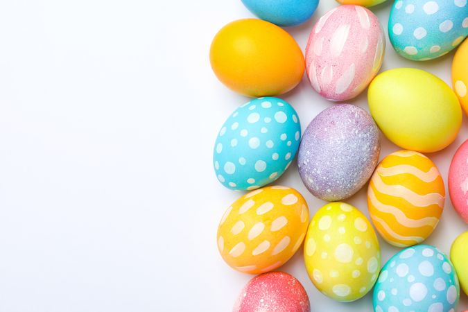 Decorative Easter eggs on neutral background, space for text. Top view