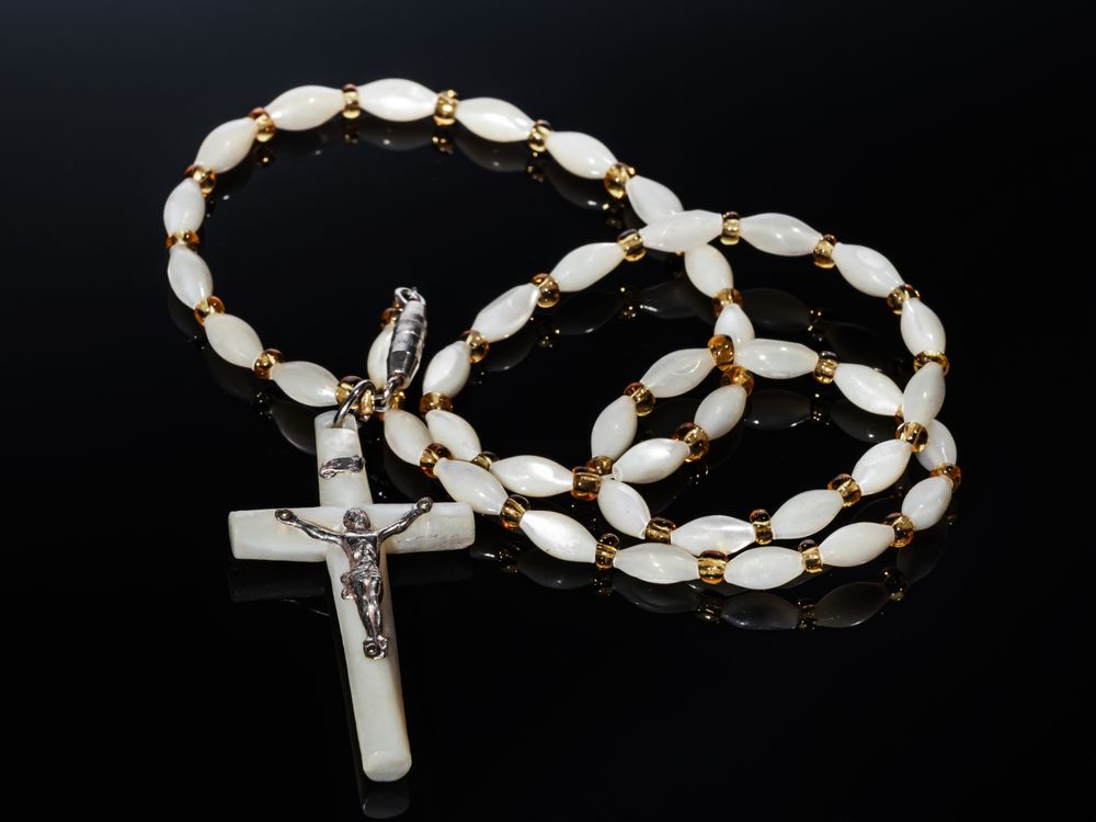 Catholic cross made of silver and mother-of-pearl. Antique jewelry.