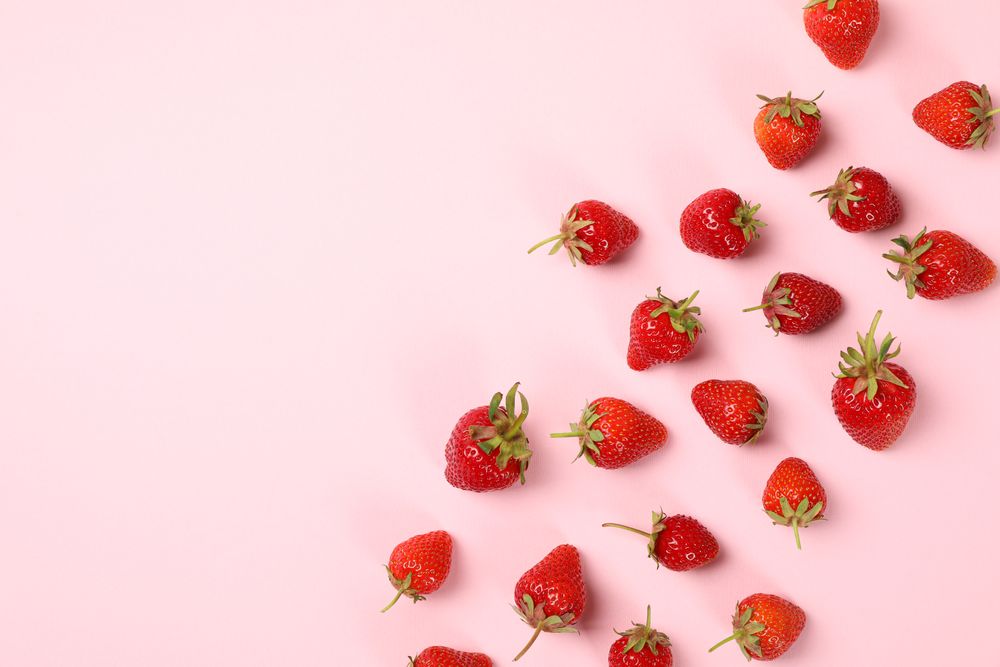 Flat lay with tasty strawberry on pink background, top view. Summer berry