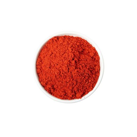 Bowl of pepper powder spice isolated on blank background