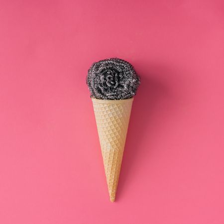 Ice cream cone with steel wool on pink background