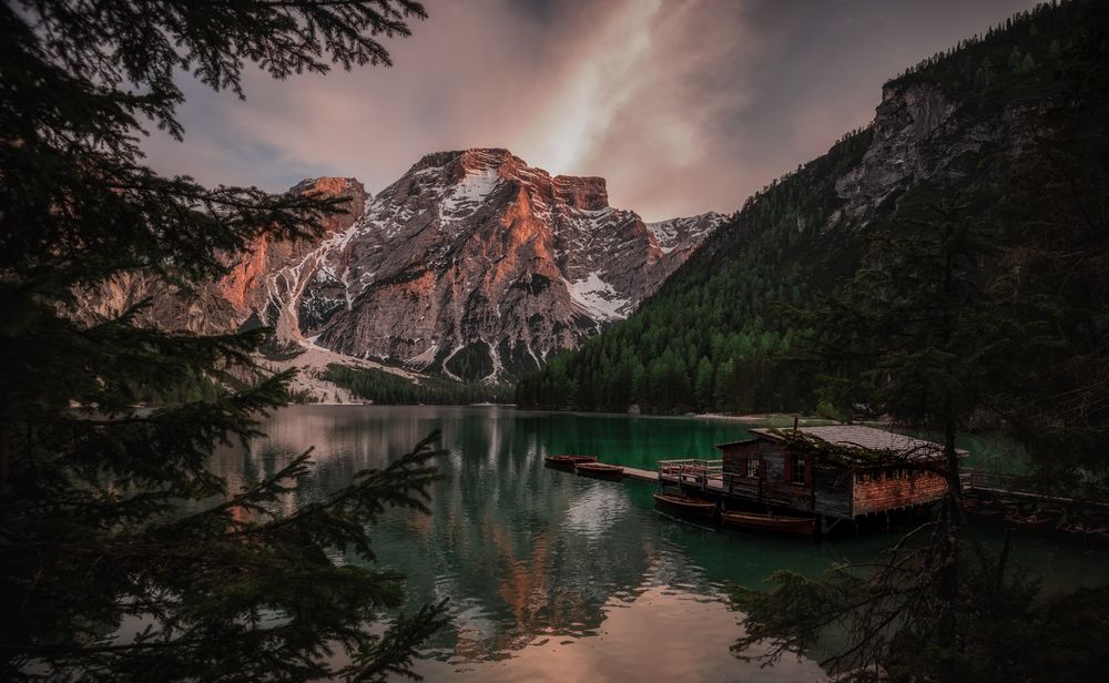 Houseboat surrounded with mountains on serene lake