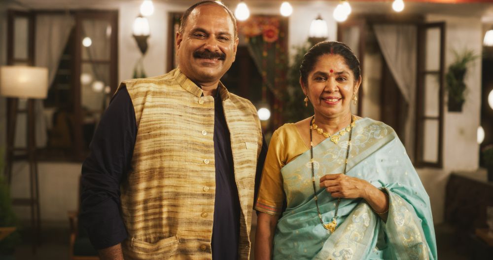 Portrait of Happy Indian Couple in Traditional Clothes Posing Together at Their Authentic Mumbai Home.