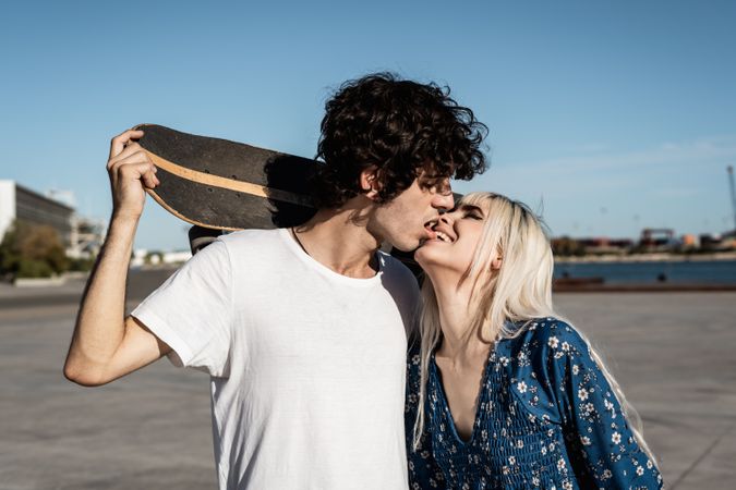 Trendy in love couple hugging on street