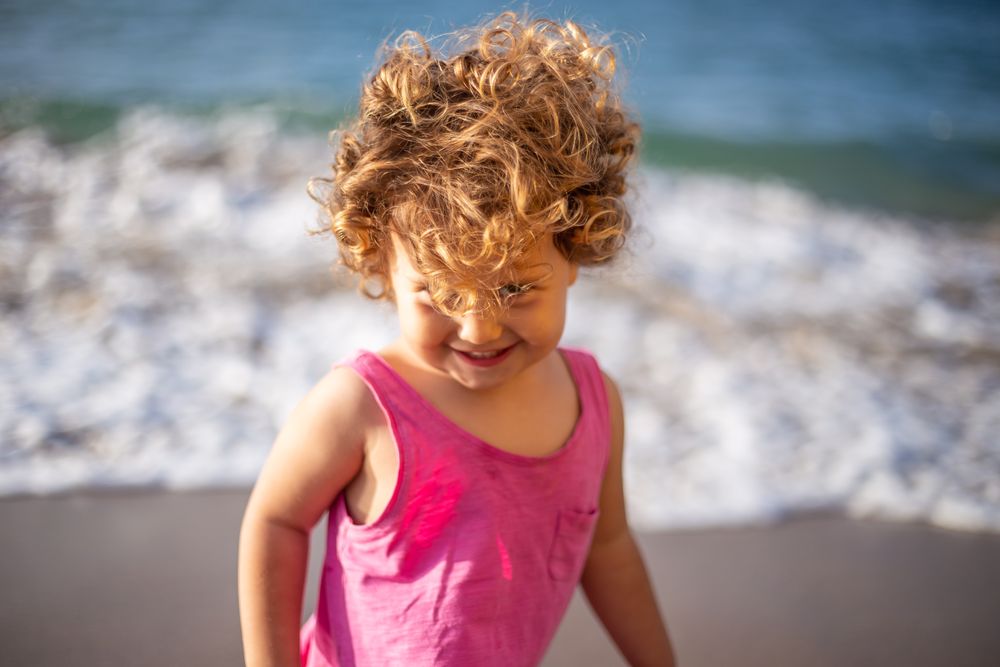 Child near sea on coast
