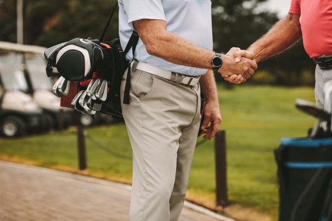 Golfers greeting each other with a handshake before the game