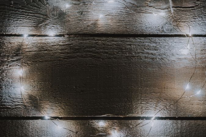 Christmas tree lights decoration on bright wooden background