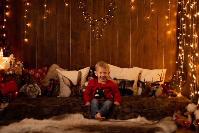 Little boy surrounded by christmas decoration