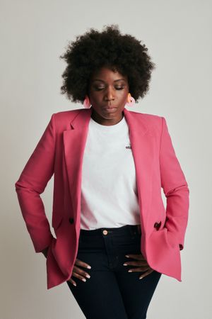 Woman in pink blazer looking down