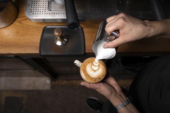Barista making coffee with latte art