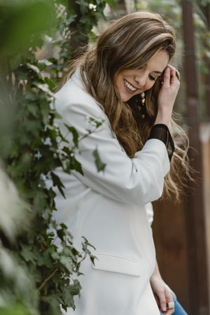 Woman sitting on planter in garden