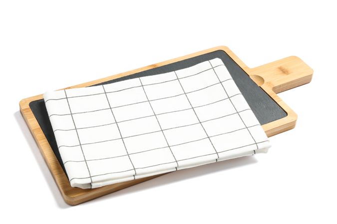 Cutting board with kitchen towel isolated on plain background