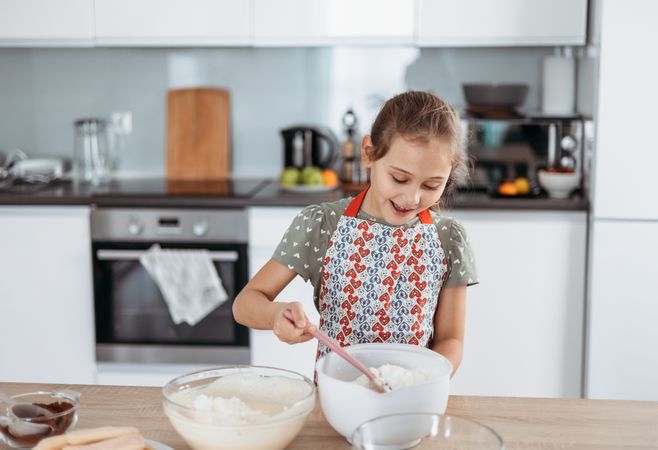 tiramisu making process in the kitchen- little girl making famous Italian dessert